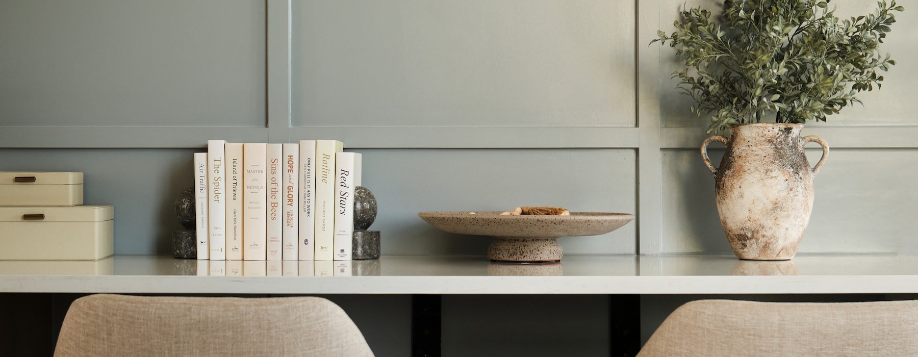 seating and table with small plant and books