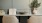 seating and table with small plant and books