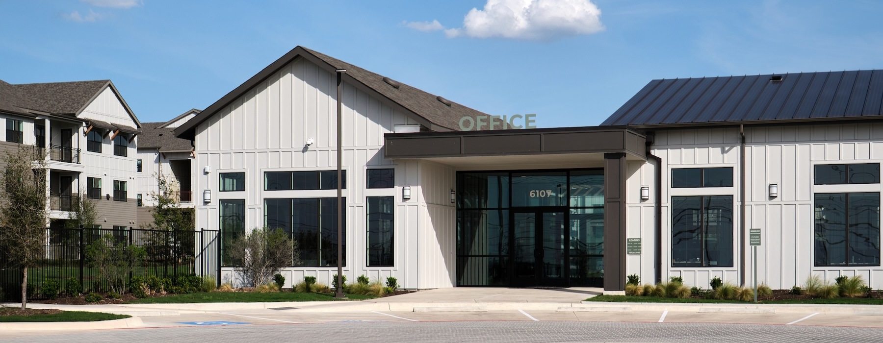 a building with a circular drive way and parking