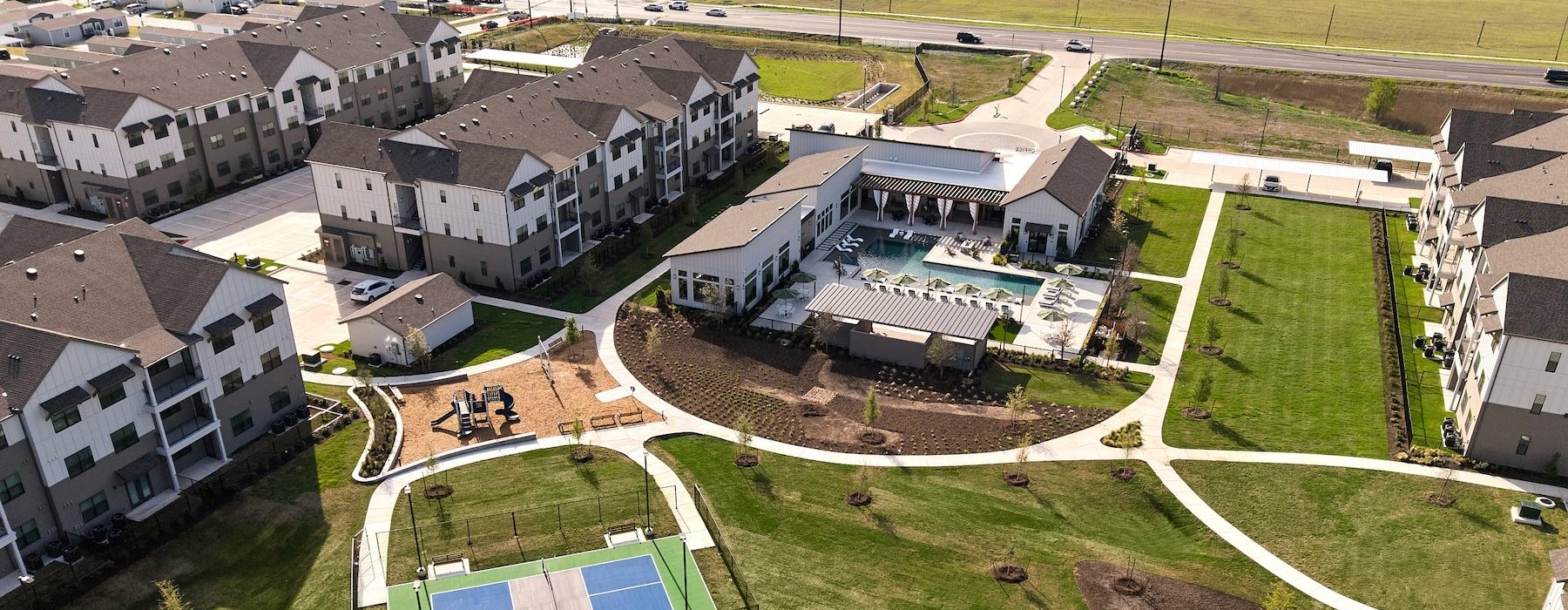 aerial view of building and pickleball court