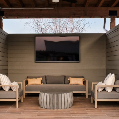 A perfect fit for the whole family covered patio with seating and tv